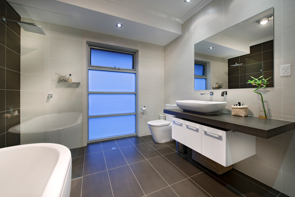 Пример оригинального дизайна: главная ванная комната в современном стиле с плоскими фасадами, белыми фасадами, отдельно стоящей ванной, открытым душем, серыми стенами, настольной раковиной и открытым душем