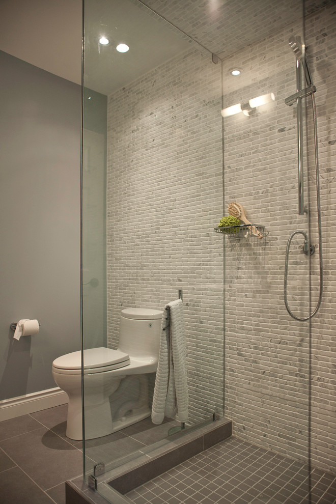 Foto de cuarto de baño contemporáneo pequeño con ducha esquinera, baldosas y/o azulejos grises, baldosas y/o azulejos en mosaico, paredes grises, suelo de baldosas de porcelana, aseo y ducha y sanitario de una pieza