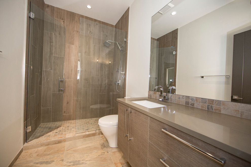 Inspiration for a large classic shower room bathroom in Seattle with flat-panel cabinets, dark wood cabinets, an alcove shower, brown tiles, porcelain tiles, white walls, porcelain flooring, a submerged sink, a one-piece toilet and quartz worktops.