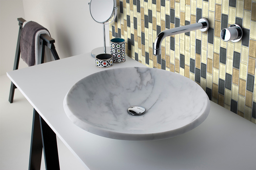 Cette image montre une salle de bain principale design de taille moyenne avec un carrelage beige, un carrelage en pâte de verre, un mur blanc, une vasque et un plan de toilette en marbre.
