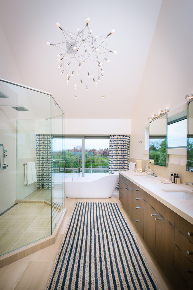 Foto de cuarto de baño principal actual grande con lavabo bajoencimera, armarios con paneles lisos, puertas de armario de madera en tonos medios, bañera exenta, ducha doble y paredes beige