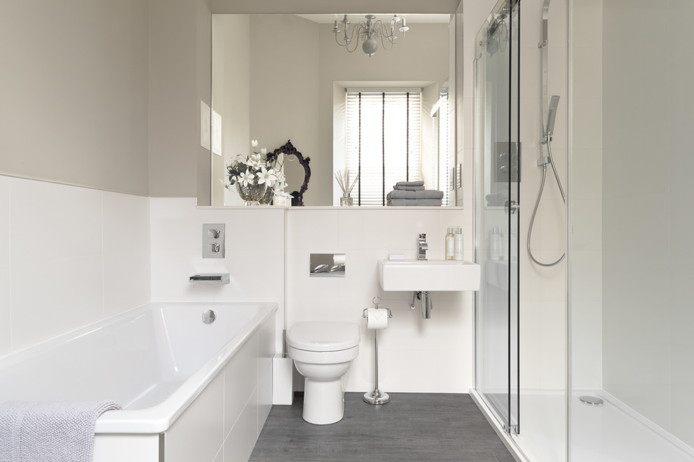 Ejemplo de cuarto de baño gris y blanco contemporáneo con lavabo suspendido, bañera encastrada, ducha empotrada, paredes grises, sanitario de una pieza y suelo gris