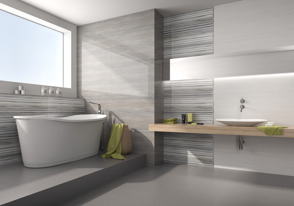 Example of a large trendy master ceramic tile and beige tile ceramic tile bathroom design in Los Angeles with gray walls, flat-panel cabinets, light wood cabinets, a one-piece toilet, a pedestal sink and solid surface countertops