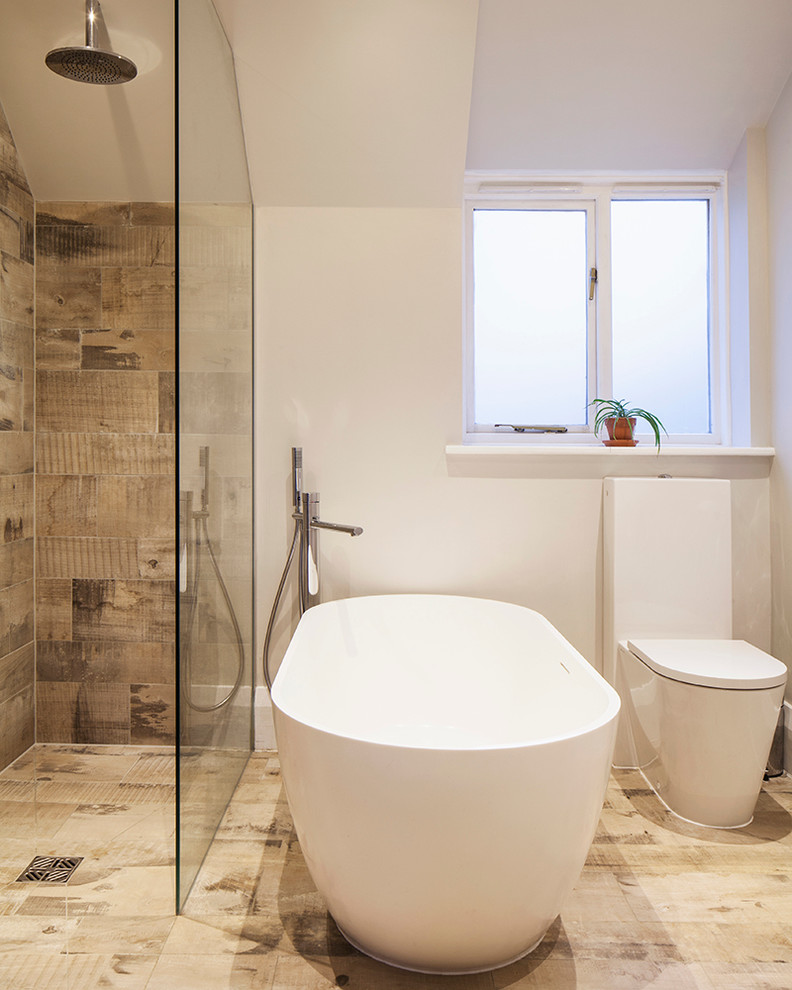 Design ideas for a medium sized contemporary family bathroom in Sussex with a freestanding bath, a walk-in shower, a wall mounted toilet, brown tiles, white walls, ceramic flooring and a built-in sink.