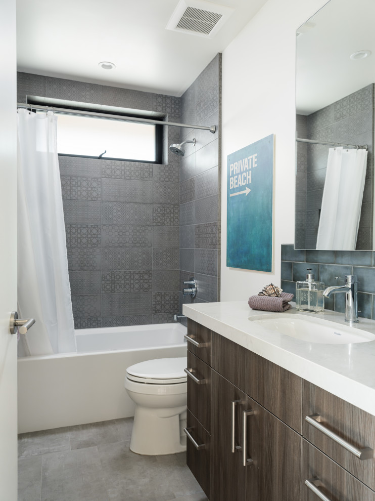 Inredning av ett modernt vit vitt badrum, med släta luckor, grå skåp, ett badkar i en alkov, en dusch/badkar-kombination, grå kakel, vita väggar, ett undermonterad handfat, grått golv och dusch med duschdraperi