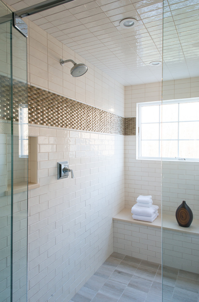 Inspiration for a large contemporary beige tile and subway tile porcelain tile alcove shower remodel in New York with furniture-like cabinets, dark wood cabinets, beige walls, an undermount sink, solid surface countertops and a hinged shower door