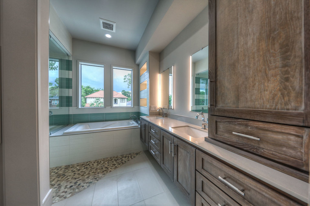 Example of a large trendy master green tile and glass tile ceramic tile and multicolored floor bathroom design in Houston with recessed-panel cabinets, dark wood cabinets, a two-piece toilet, red walls, an undermount sink, quartz countertops and beige countertops