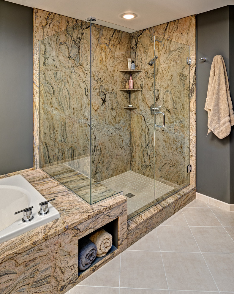 Design ideas for a medium sized contemporary ensuite bathroom in Minneapolis with a submerged sink, flat-panel cabinets, light wood cabinets, granite worktops, a built-in bath, beige tiles, porcelain tiles, grey walls and porcelain flooring.