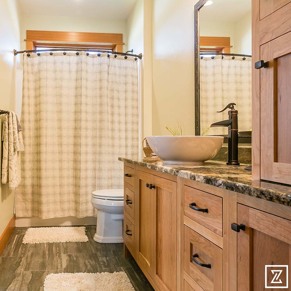 Photo of a small classic shower room bathroom in Other with shaker cabinets, light wood cabinets, an alcove bath, a shower/bath combination, a two-piece toilet, beige walls, slate flooring, a pedestal sink and granite worktops.