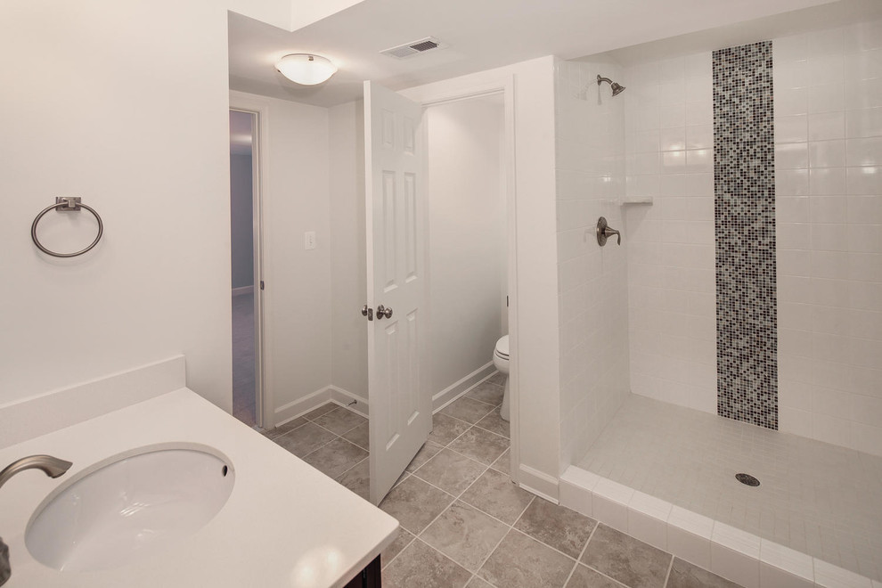 Transitional master white tile and subway tile porcelain tile bathroom photo in DC Metro with an undermount sink, recessed-panel cabinets, dark wood cabinets, quartz countertops, a two-piece toilet and gray walls