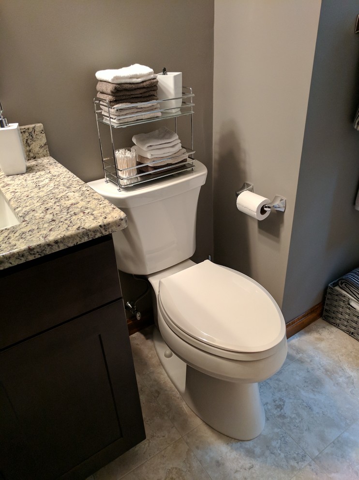 Medium sized contemporary family bathroom in Boston with flat-panel cabinets, grey cabinets, a two-piece toilet, brown walls, vinyl flooring, a submerged sink, granite worktops and beige floors.