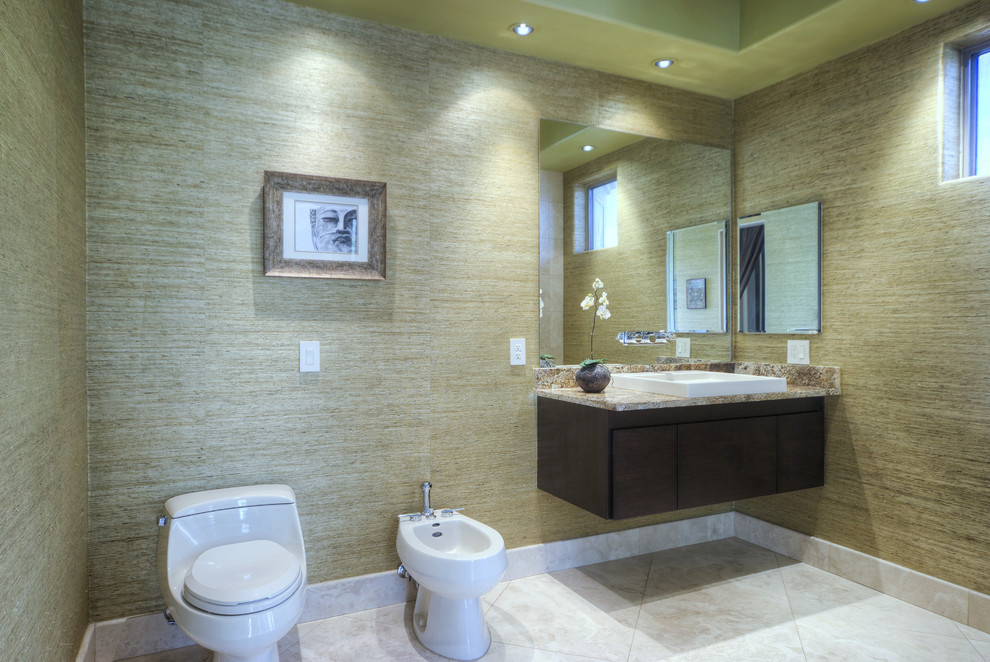 Inspiration for a large contemporary ensuite bathroom in Phoenix with a vessel sink, flat-panel cabinets, dark wood cabinets, granite worktops, a walk-in shower, a one-piece toilet, beige tiles, stone tiles, green walls and travertine flooring.