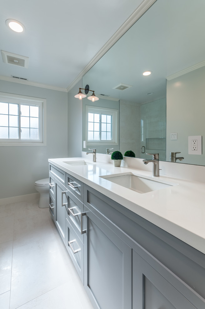 Design ideas for a medium sized traditional family bathroom in San Francisco with shaker cabinets, white cabinets, an alcove shower, a one-piece toilet, grey tiles, porcelain tiles, green walls, porcelain flooring, a submerged sink and quartz worktops.
