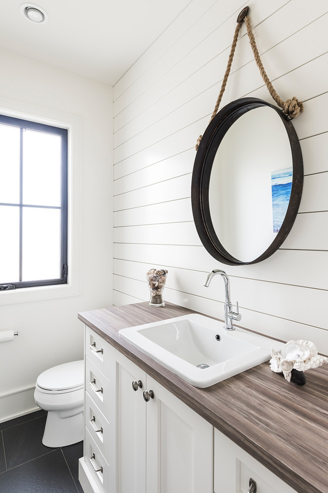 Imagen de cuarto de baño de estilo de casa de campo grande con armarios estilo shaker, puertas de armario blancas, sanitario de una pieza, paredes blancas, aseo y ducha y lavabo de seno grande