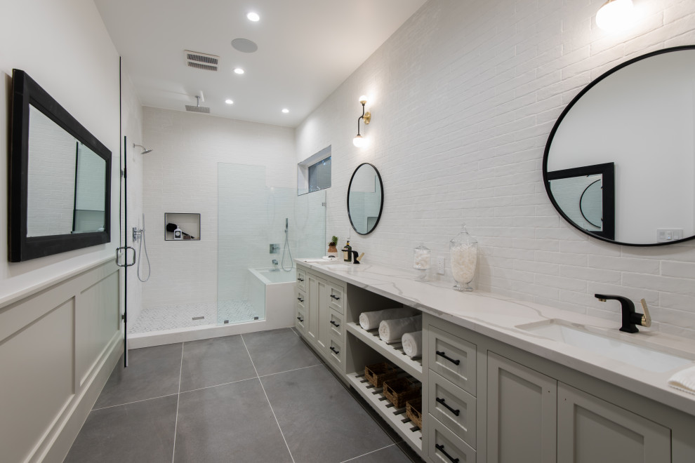 Inspiration for an expansive contemporary shower room bathroom in Los Angeles with shaker cabinets, grey cabinets, a shower/bath combination, grey tiles, white walls, a submerged sink, grey floors, an open shower, beige worktops, a wall niche, a shower bench and wainscoting.