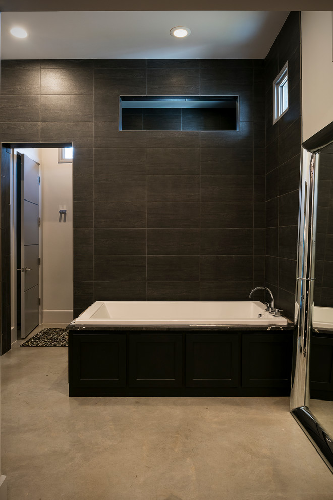 Design ideas for a contemporary ensuite bathroom in Dallas with a corner bath, grey walls and concrete flooring.