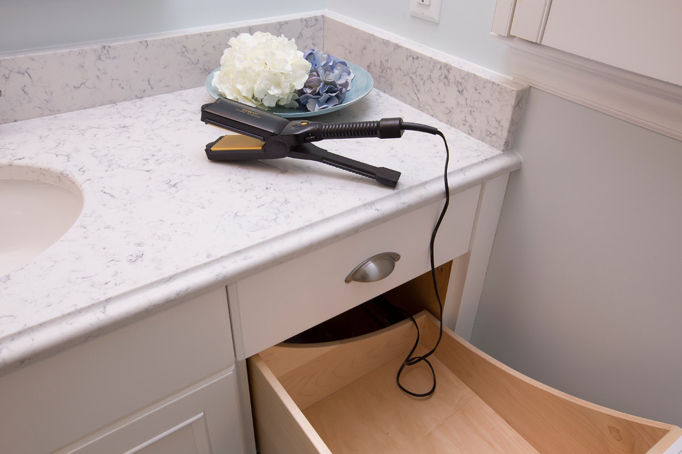 Small contemporary family bathroom in Raleigh with recessed-panel cabinets, white cabinets, an alcove bath, a shower/bath combination, a two-piece toilet, white tiles, cement tiles, blue walls, ceramic flooring, a submerged sink, engineered stone worktops, grey floors, a hinged door and white worktops.