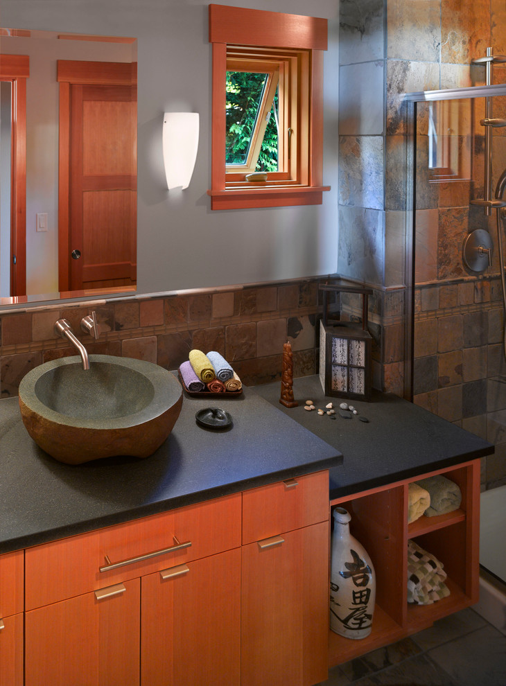 Example of a mid-sized master stone tile and multicolored tile slate floor and gray floor bathroom design in Seattle with a vessel sink, flat-panel cabinets, gray walls, medium tone wood cabinets and concrete countertops