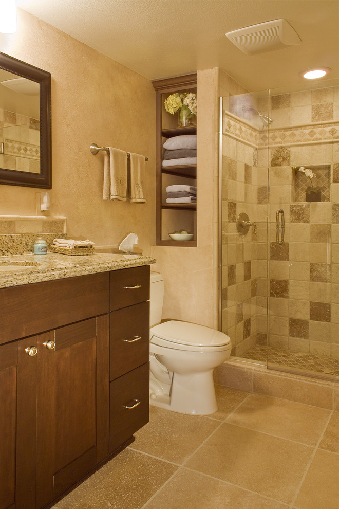 Mid-sized trendy beige tile and porcelain tile porcelain tile alcove shower photo in Los Angeles with shaker cabinets, dark wood cabinets, a two-piece toilet, beige walls, an undermount sink and granite countertops