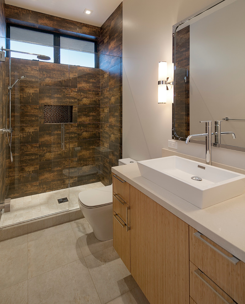 Photo of a medium sized contemporary family bathroom in Santa Barbara with flat-panel cabinets, light wood cabinets, an alcove shower, a one-piece toilet, brown tiles, stone tiles, white walls, porcelain flooring, a vessel sink and engineered stone worktops.