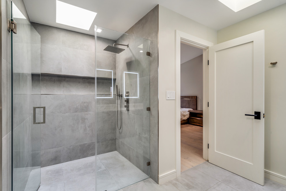 Example of a mid-sized trendy master brown tile and cement tile porcelain tile and brown floor alcove shower design in San Francisco with flat-panel cabinets, medium tone wood cabinets, a one-piece toilet, beige walls, a vessel sink, quartzite countertops, a hinged shower door and white countertops