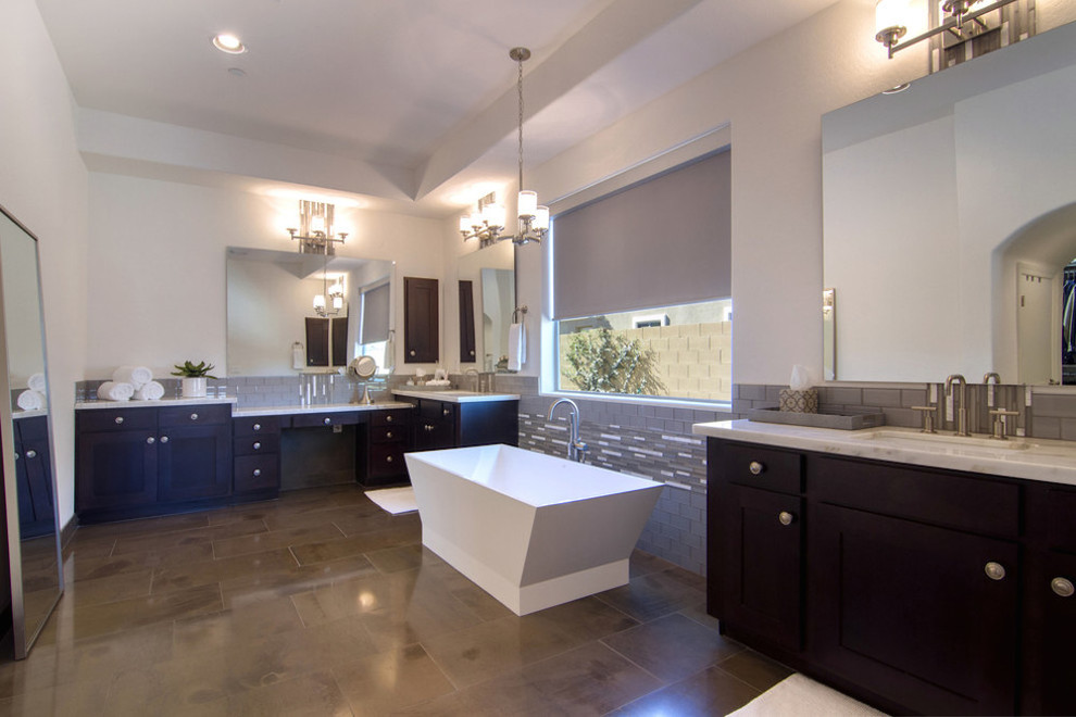 This is an example of a contemporary shower room bathroom in Phoenix with a built-in sink, flat-panel cabinets, dark wood cabinets, marble worktops, a freestanding bath, an alcove shower, a one-piece toilet, white tiles, ceramic tiles and beige walls.