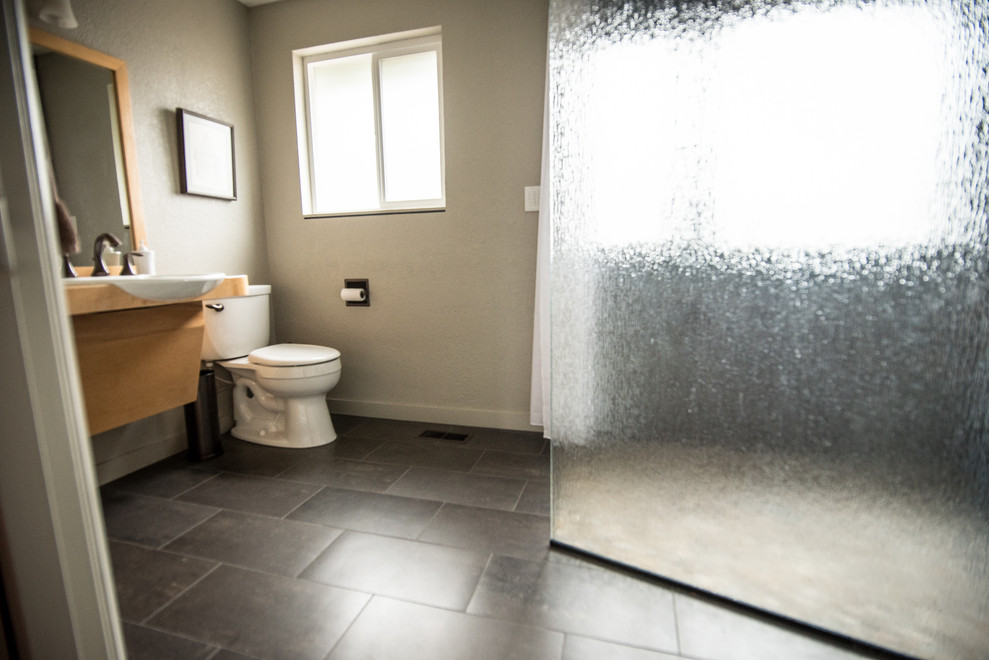 Bathroom - large contemporary master gray tile and ceramic tile ceramic tile and gray floor bathroom idea in Portland with flat-panel cabinets, brown cabinets, a two-piece toilet, white walls and a drop-in sink