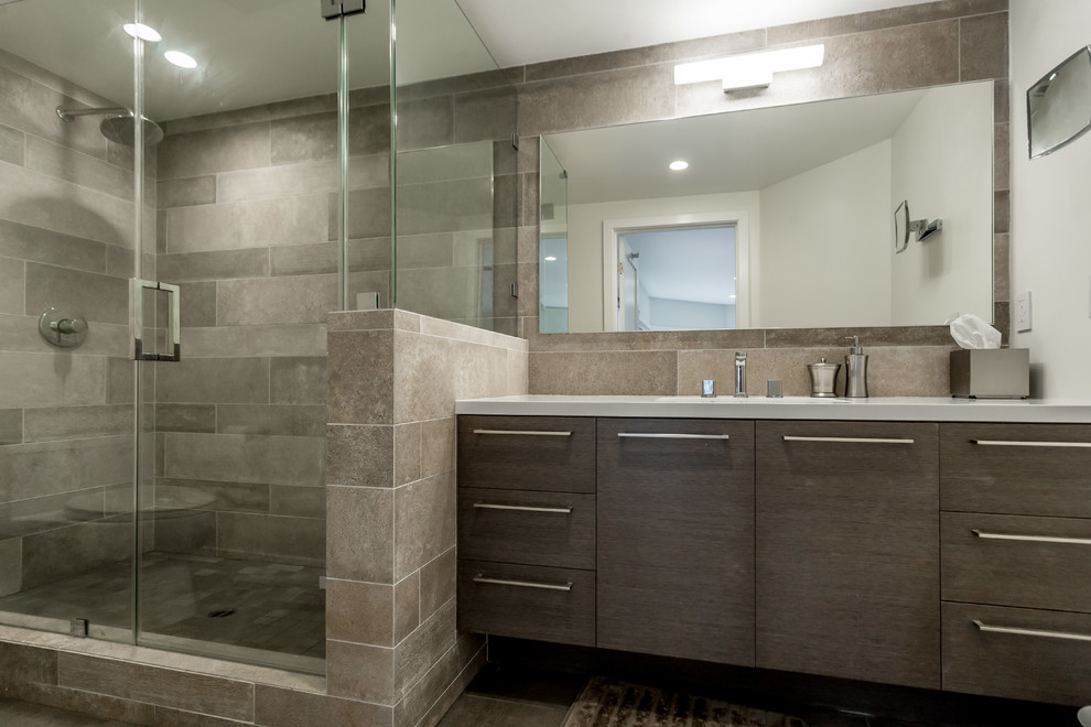 This is an example of a large contemporary bathroom in San Francisco with flat-panel cabinets, dark wood cabinets, a corner shower, an integrated sink, solid surface worktops and a hinged door.