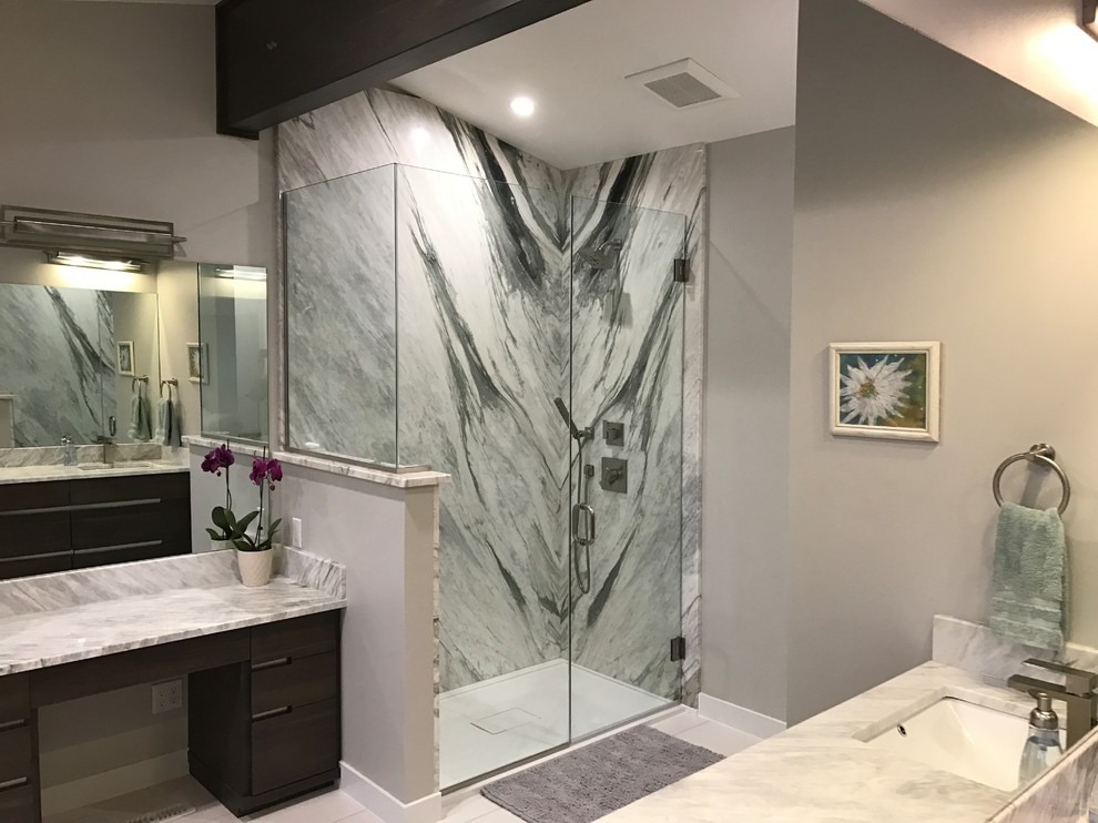 Design ideas for a medium sized traditional ensuite bathroom in Calgary with flat-panel cabinets, dark wood cabinets, a corner shower, grey tiles, stone slabs, grey walls, a submerged sink, marble worktops and a hinged door.