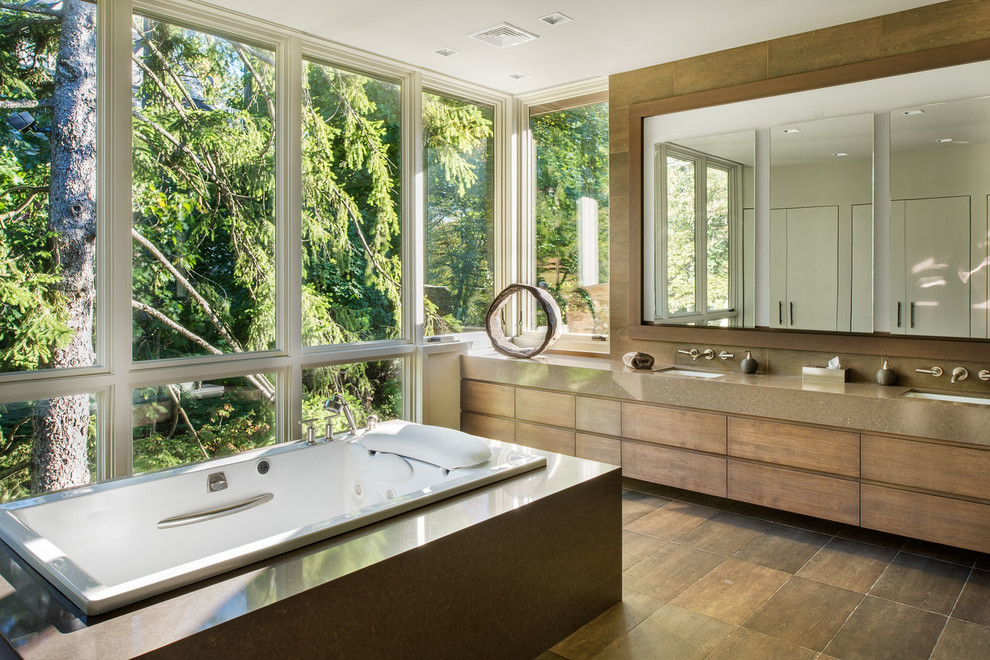 Aménagement d'une salle de bain contemporaine en bois brun avec un lavabo encastré, un placard à porte plane, une baignoire posée, un carrelage marron et un plan de toilette marron.