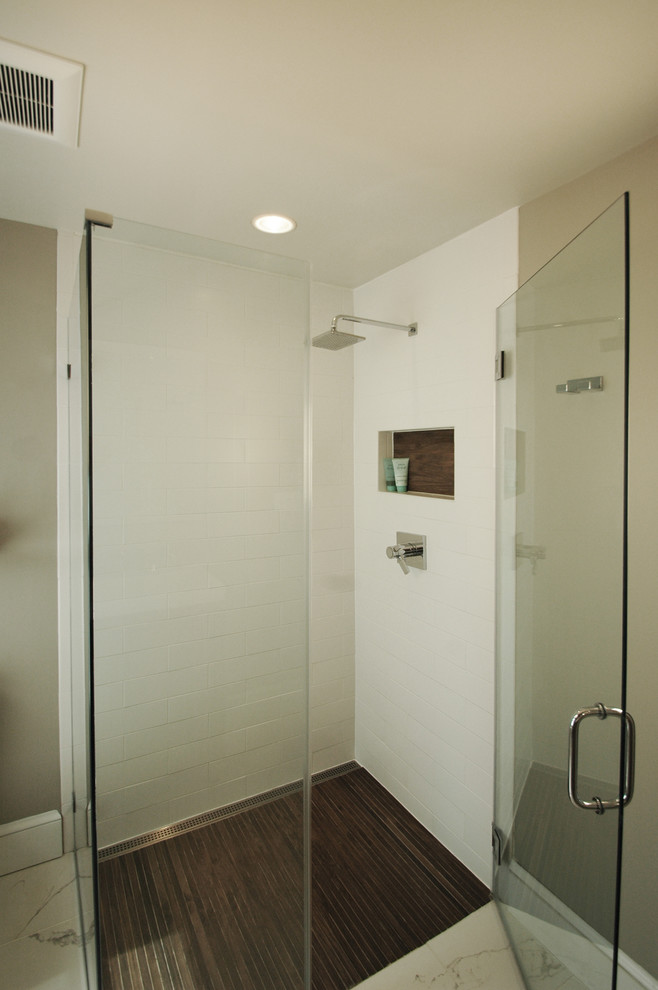 Example of a small trendy master white tile and stone tile marble floor walk-in shower design in DC Metro with a trough sink, shaker cabinets, medium tone wood cabinets, a two-piece toilet and gray walls