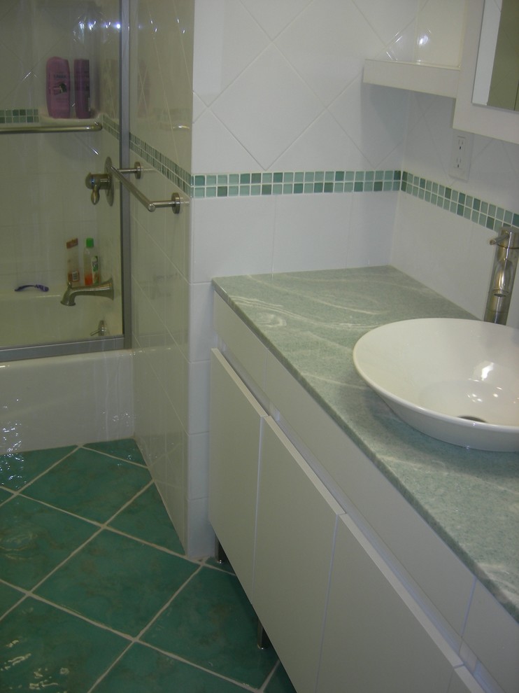 This is an example of a small contemporary family bathroom in New York with a vessel sink, flat-panel cabinets, white cabinets, solid surface worktops, an alcove bath, a shower/bath combination, a two-piece toilet, multi-coloured tiles, porcelain tiles, multi-coloured walls and porcelain flooring.