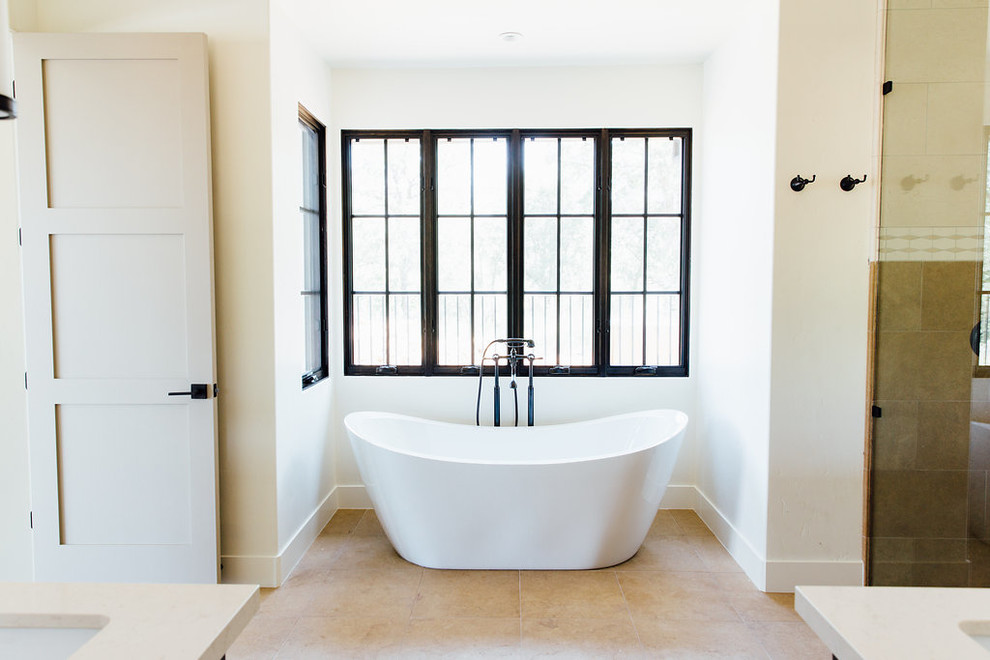 Cette photo montre une douche en alcôve principale craftsman de taille moyenne avec une baignoire indépendante, un carrelage de pierre, un lavabo encastré, un plan de toilette en surface solide, un mur blanc et un sol en travertin.