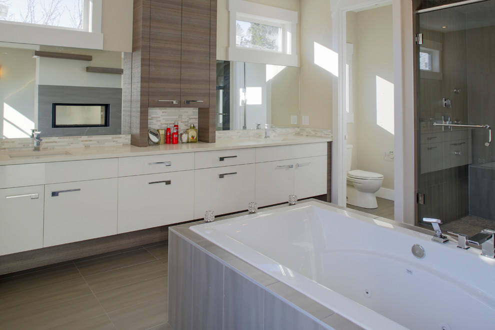 Large trendy master bathroom photo in Calgary with flat-panel cabinets, white cabinets, a one-piece toilet, white walls and an undermount sink
