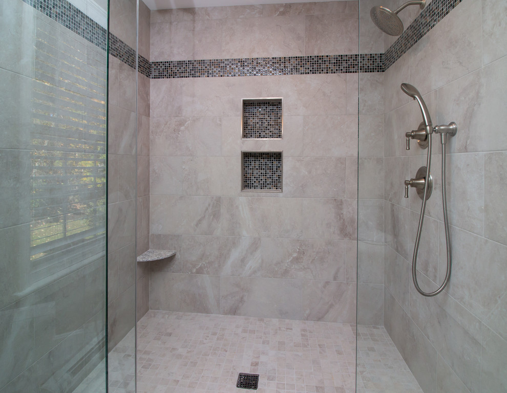 Alcove shower - mid-sized contemporary master white tile and porcelain tile porcelain tile and white floor alcove shower idea in Manchester with raised-panel cabinets, white cabinets, a two-piece toilet, gray walls, an undermount sink, quartz countertops, a hinged shower door and multicolored countertops