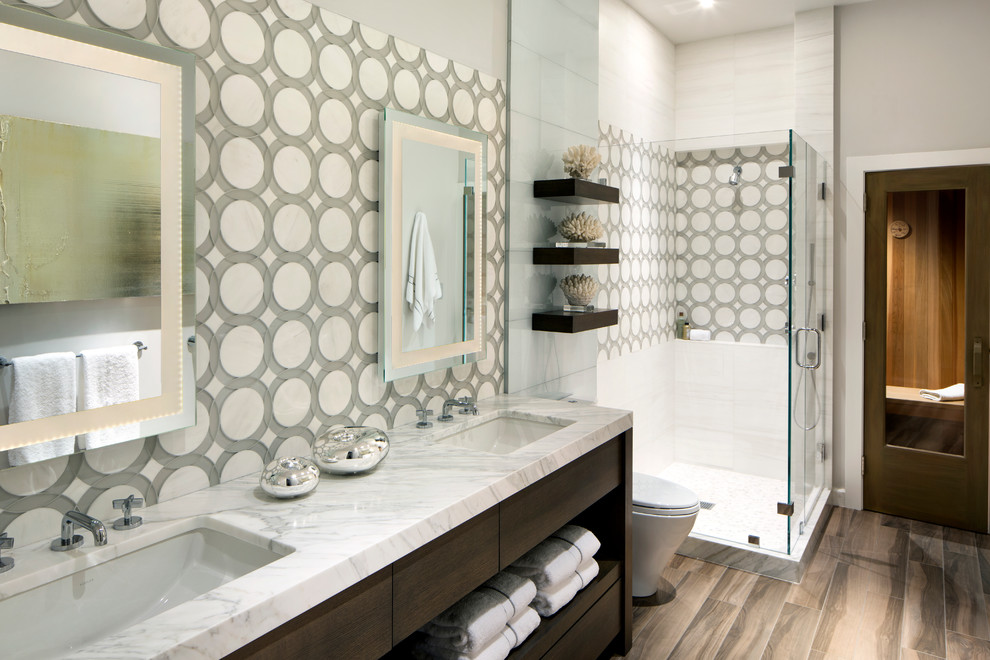 Photo of a medium sized contemporary shower room bathroom in San Francisco with flat-panel cabinets, dark wood cabinets, an alcove shower, a one-piece toilet, grey tiles, white tiles, cement tiles, multi-coloured walls, medium hardwood flooring, a submerged sink, marble worktops, brown floors and a hinged door.
