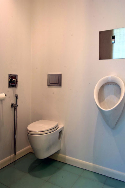 Diseño de cuarto de baño principal actual de tamaño medio con urinario, paredes blancas y suelo de baldosas de porcelana