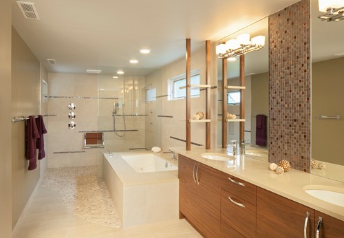Luxury bathroom cabinets with wood veneer finish, double sinks, quartz countertop, and built-in shelving beside a spa-style bathtub and glass shower