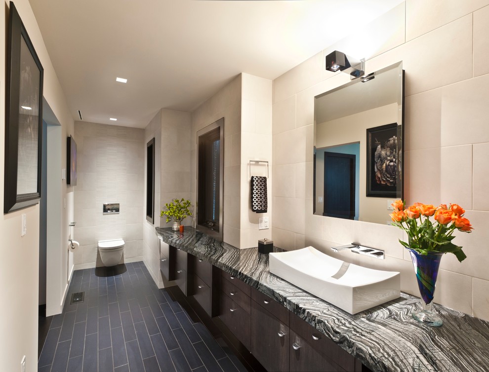 Example of a mid-sized trendy slate floor and gray floor bathroom design in Seattle with gray cabinets, white walls, a vessel sink and onyx countertops
