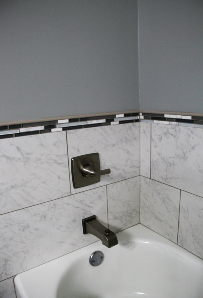 Foto på ett stort funkis svart en-suite badrum, med luckor med upphöjd panel, vita skåp, ett badkar i en alkov, en dusch i en alkov, en toalettstol med hel cisternkåpa, flerfärgad kakel, keramikplattor, grå väggar, klinkergolv i keramik, ett undermonterad handfat, granitbänkskiva, grått golv och dusch med gångjärnsdörr