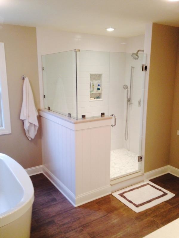 Bathroom - large contemporary master white tile medium tone wood floor bathroom idea in Boston with an undermount sink, recessed-panel cabinets, white cabinets, brown walls, a two-piece toilet and quartz countertops