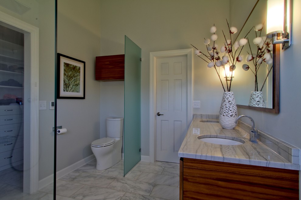 Immagine di una stanza da bagno design con lavabo sottopiano, ante lisce, ante in legno scuro, top in quarzite, WC a due pezzi, piastrelle bianche e piastrelle in pietra