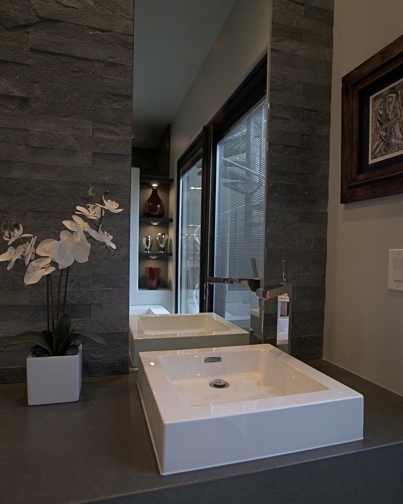 Mid-sized trendy master gray tile and stone tile concrete floor bathroom photo in Phoenix with a vessel sink, flat-panel cabinets, dark wood cabinets, concrete countertops and gray walls
