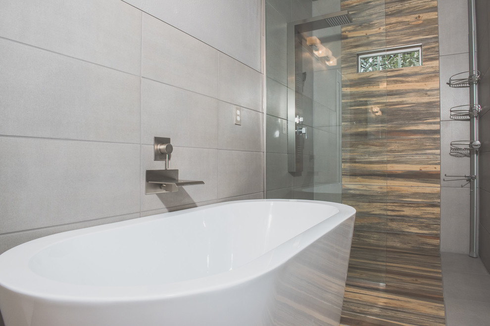 Idée de décoration pour une salle de bain principale design en bois brun de taille moyenne avec un placard à porte plane, un bain bouillonnant, une douche ouverte, WC à poser, un carrelage gris, un mur gris, un lavabo suspendu, un sol gris, aucune cabine et un plan de toilette blanc.