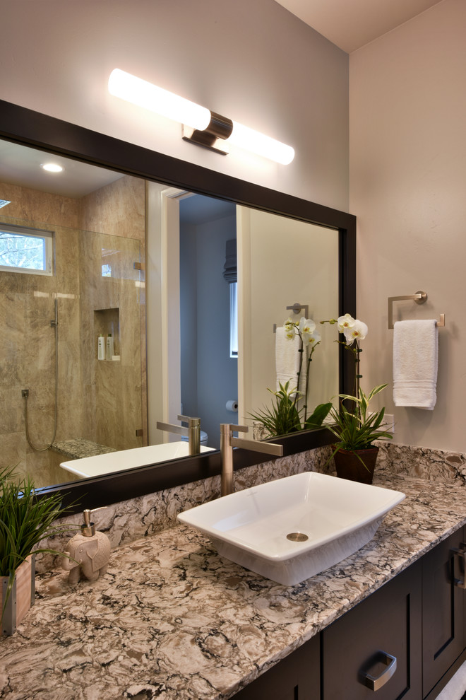 This is an example of a large contemporary ensuite bathroom in Tampa with shaker cabinets, brown cabinets, an alcove shower, a one-piece toilet, beige tiles, porcelain tiles, grey walls, porcelain flooring, a vessel sink, engineered stone worktops, beige floors, a hinged door and multi-coloured worktops.