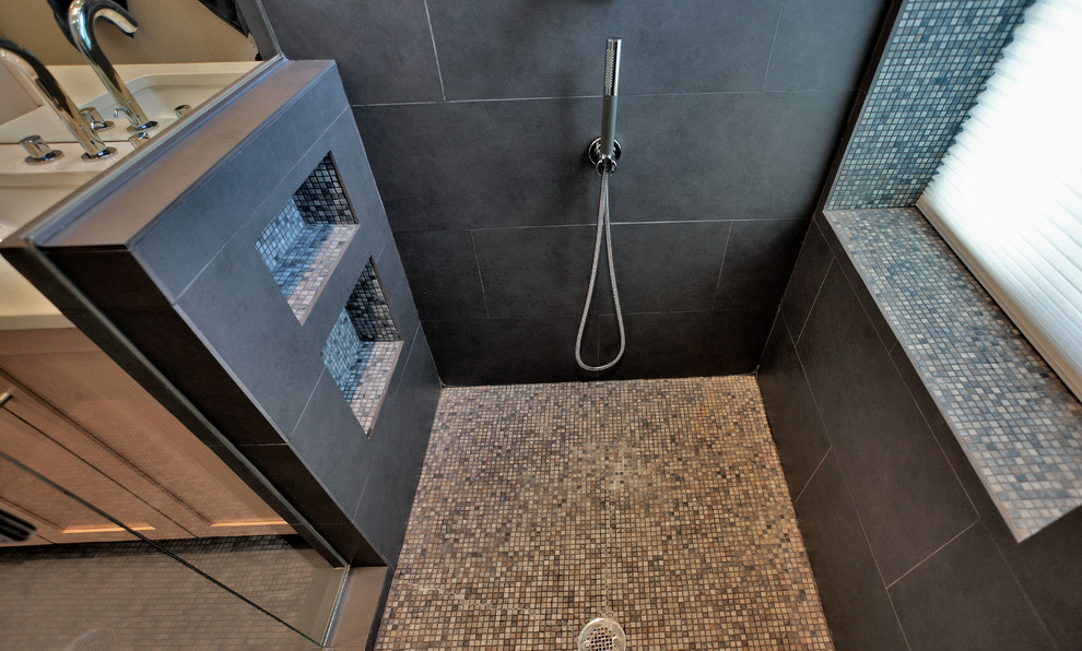 This is an example of a large contemporary ensuite bathroom in DC Metro with a submerged sink, shaker cabinets, light wood cabinets, engineered stone worktops, an alcove shower, a one-piece toilet, grey tiles, porcelain tiles, white walls and porcelain flooring.