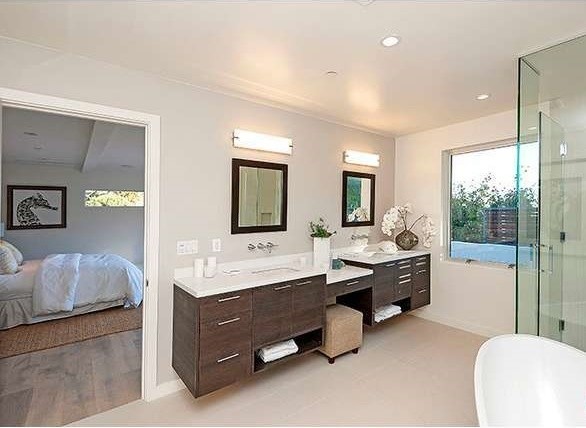 Inspiration for a large contemporary ensuite bathroom in Los Angeles with a submerged sink, flat-panel cabinets, dark wood cabinets, engineered stone worktops, a freestanding bath, a corner shower, grey tiles, ceramic tiles, white walls and ceramic flooring.