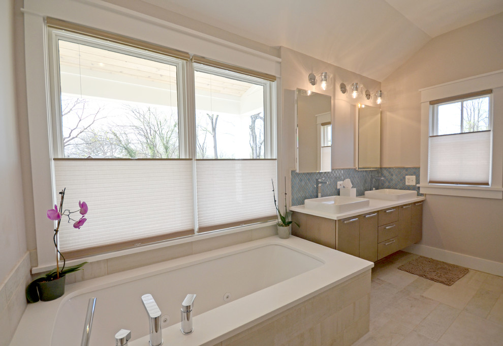Example of a mid-sized cottage master porcelain tile and beige floor doorless shower design in DC Metro with flat-panel cabinets, light wood cabinets, quartz countertops, an undermount tub, a two-piece toilet, beige walls, a vessel sink and a hinged shower door