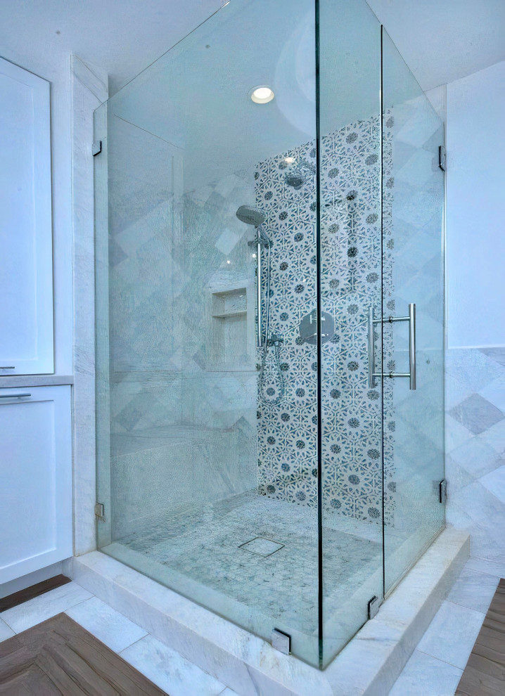 Design ideas for a medium sized mediterranean ensuite bathroom in Los Angeles with shaker cabinets, white cabinets, a corner shower, a one-piece toilet, white tiles, marble tiles, white walls, marble flooring, a submerged sink, marble worktops, multi-coloured floors, a hinged door, white worktops, a shower bench, double sinks, a built in vanity unit and a drop ceiling.