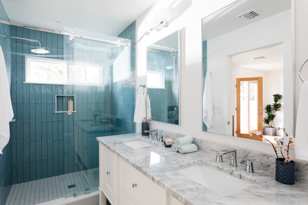 Open shower - transitional blue tile and porcelain tile open shower idea in Los Angeles with recessed-panel cabinets, white cabinets, white walls, an undermount sink, marble countertops and multicolored countertops